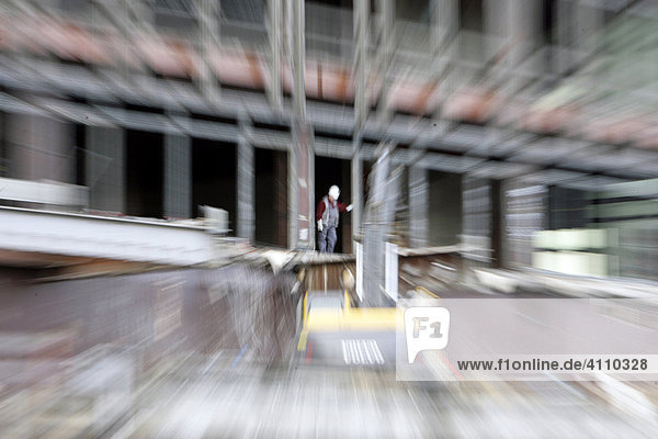 Worker and digger tear down the Palace of the Republik in Berlin