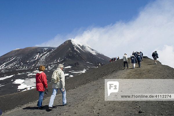 Tourists hiking to Mt. Etna  smoke  Sicily  Italy