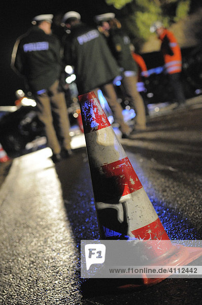 Police behind a traffic cone used to secure the scene of a traffic accident  Gomadingen  Reutlingen Region  Baden-Wuerttemberg  Germany  Europe