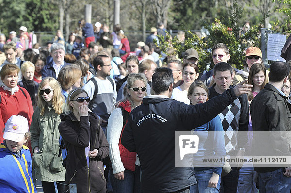 Zoo visitors primarily to see the polar bear cub named Wilbaer security services ensuring order Wilhelma Zoo in Stuttgart Baden-Wuerttemberg Germany Europe