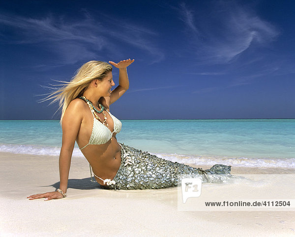 Mermaid gazing into the distance  fantasy beach  Maldives  Indian Ocean