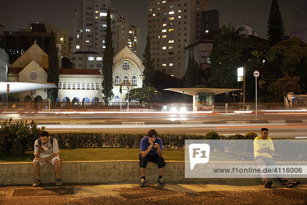 Jugendliche vor dem Hospital Santa Catarina an der nächtlichen Avenida Paulista  Sao Paulo  Brasilien