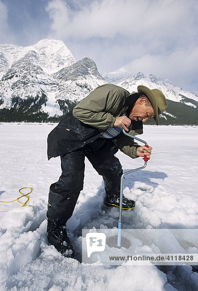 Ice Fishing on the Spray Lake  Banff National Park  Alberta  Canada