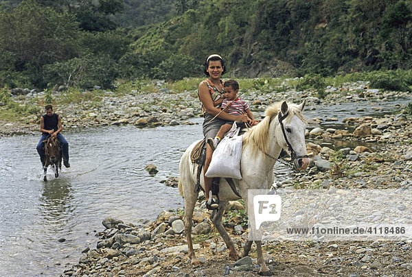 Woman and child on a horse  Sierra Maestra mountains  Cuba