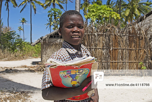 Child with school books  Matemo island  Quirimbas islands  Mozambique  Africa
