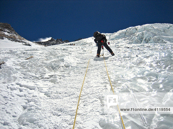 Climber on fixed ropes in the steep  icy Lhotse Face  6800m  on the way to Camp III  3  Mount Everest  Himalaya  Nepal