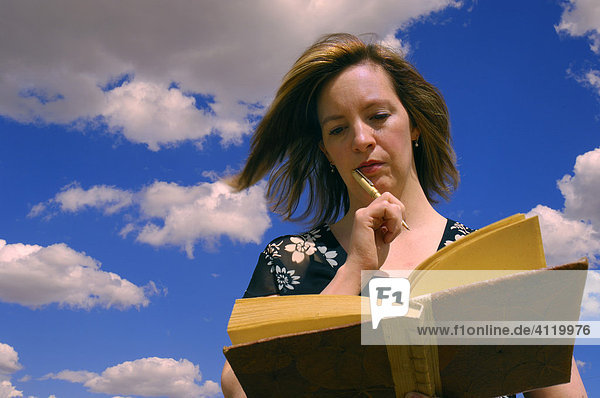 Woman making an entry in her diary