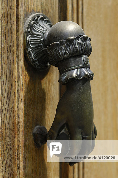 Hand door knocker on a French house