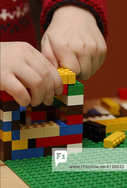 Young boy building with Lego