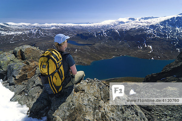 Hiker with backpack  view over mountain scenery  Jotunheimen national park  Vaga  Oppland  Norway