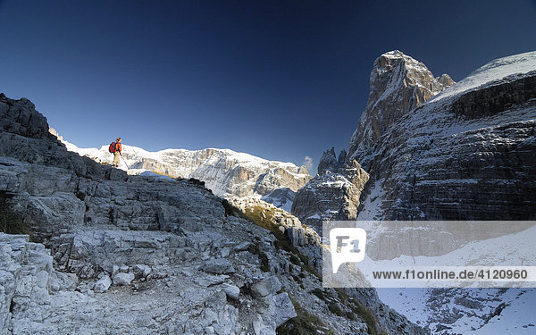 Hiker in front of the Zwoelferkogel  Sextenan Dolomites  South Tyrol  Italy
