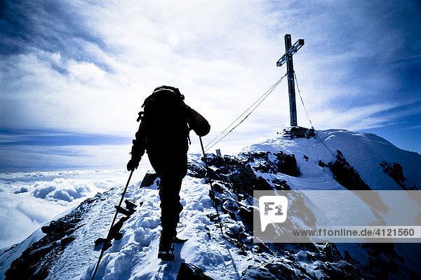 Mountain climber on the way to the peak  reaching the summit of Mt. Similaun  Tyrol  Austria  Europe