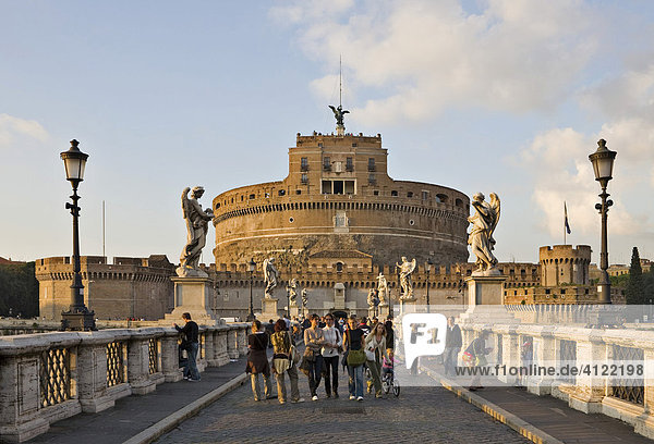 Group of tourists on Ponte Sant´ Angelo bridge with Sant´ Angelo Castle before sunset  Rome  Italy  Europe