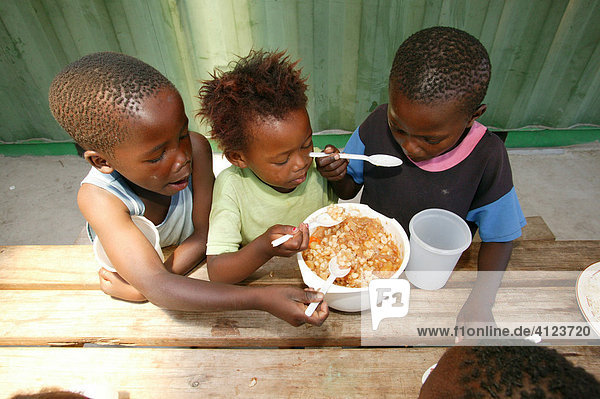 Children eating in a soup kitchen  Cape Town  South Africa