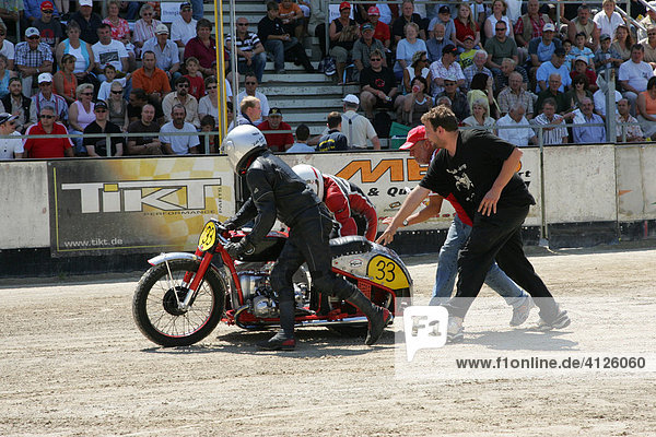 Sidecar motorcycles at the starting line  international motorcycle race on a dirt track speedway in Muehldorf am Inn  Upper Bavaria  Bavaria  Germany  Europe