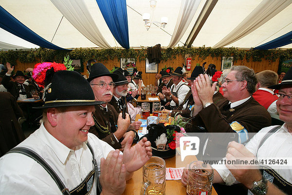 Men dressed in national costume in a beer tent at a folk festival in Muehldorf am Inn  Upper Bavaria  Bavaria  Germany  Europe