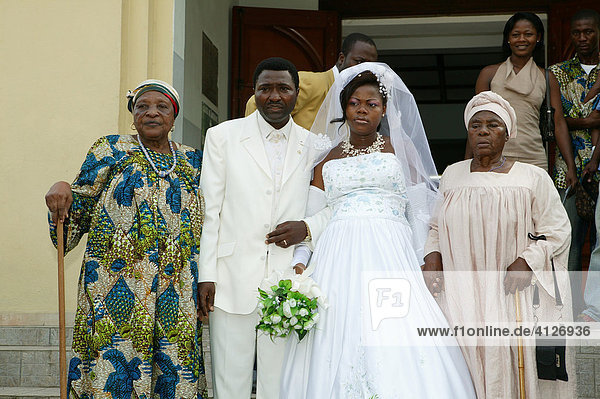Bride and groom  wedding couple leaving church between their mother-in-laws  Douala  Cameroon  Africa
