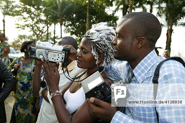 Photographer showing woman how to operate a video camera  Douala  Cameroon  Africa