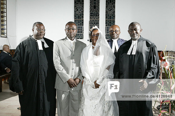 African bride and groom  bridal couple standing with pastors at their wedding  Douala  Cameroon  Africa