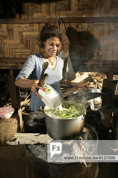 Woman preparing a meal  Biliau  Papua New Guinea  Melanesia