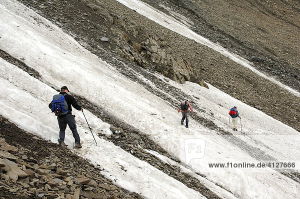 Three mountain climbers crossing a snowfield  Parseier Spitz  Lechtaler Alps  Tyrol  Austria