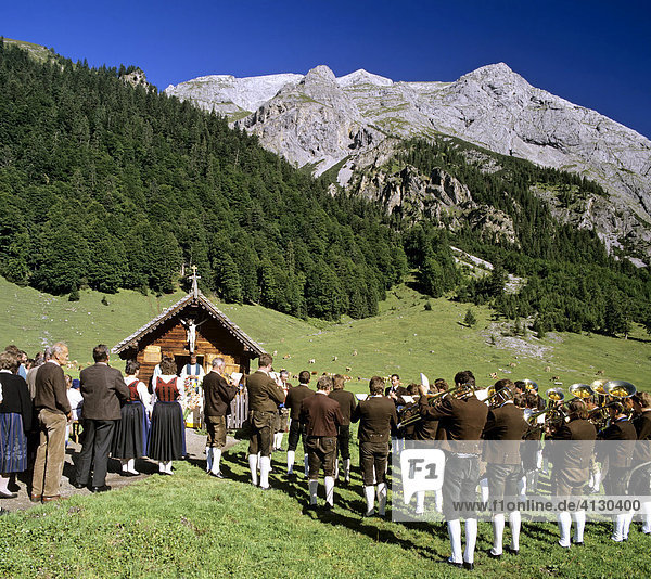 Outdoor mass held at Engalm alpine pasture  congregation dressed in traditional lederhosen  Eng  Gamsjoch  Ahornboden  Tyrol  Austria