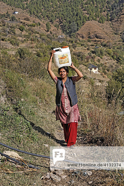 Weil die Reperatur der Wasserleitung ist zu teuer für das Dorf ist  muss die Frau das Wasser wie früher auf dem Kopf holen Matiyama  Himachal Pradesh  Indien
