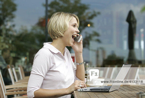 Business woman with laptop and mobile phone