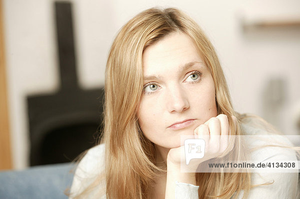 Young blonde woman pondering