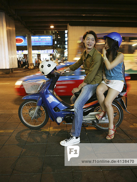 THA Thailand Bangkok Thai couple on a motorbike. |