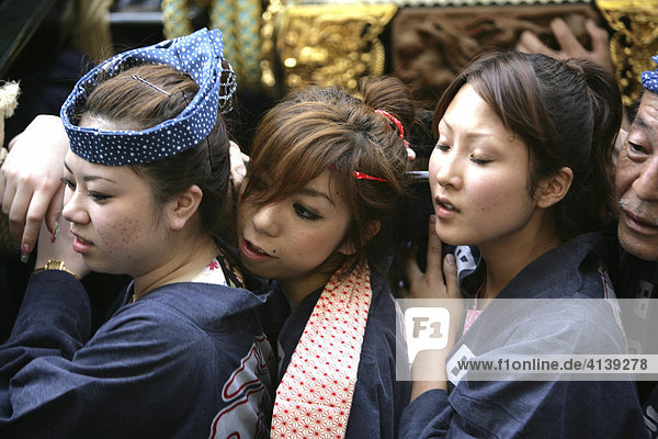 Japan  Tokyo: Shrine festival  called Matsuri. The Shinto shrines are carried through the streets of the Shinto temple district. Local people carrying the shrine on their shoulders  dressed in happi-coats  religious festival