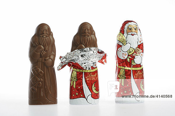 Chocolate Santas in a row  various stages of being unwrapped