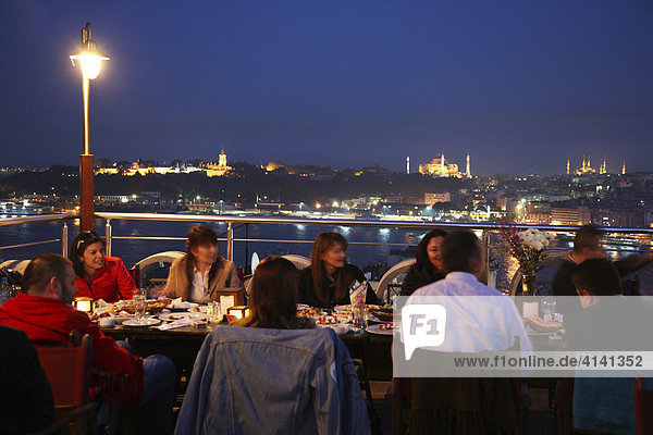 Restaurant in Galata with a view over the Eminoenue district and the Golden Horn with mosques in the distance  Istanbul  Turkey