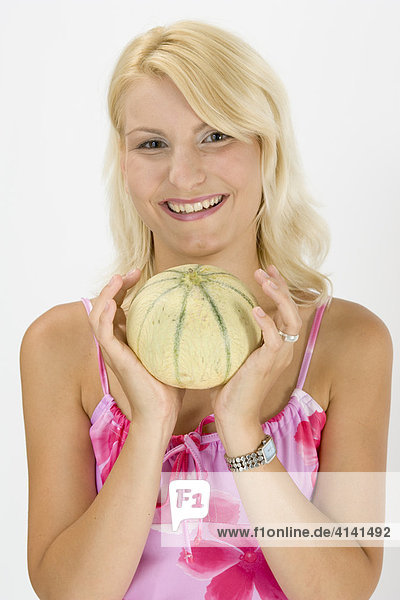Young woman holding a melon