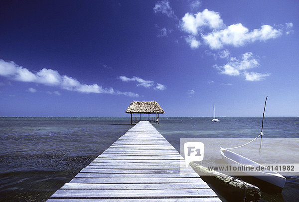 Steg mit Sonnendach und Boot auf Caye Caulker  Belize  Mittelamerika