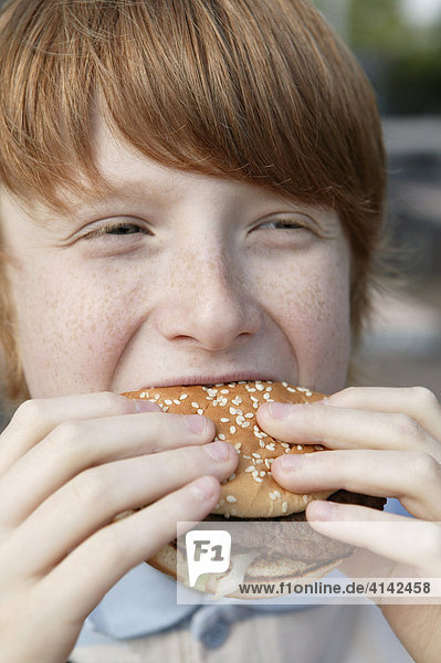 Boy eats a burger