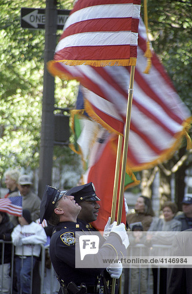 Police officers carrying US flags  New York City  New York  USA