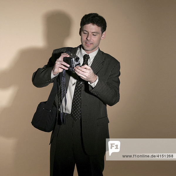 Businessman looking at a video camera