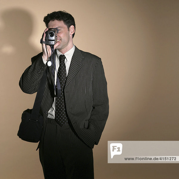 Businessman filming with a video camera
