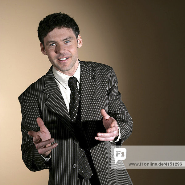 Man wearing suit gesturing with his hands