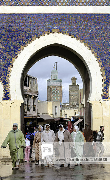 Women with headscarves in front of the gate Bab Boujeloud  Fes  Morocco