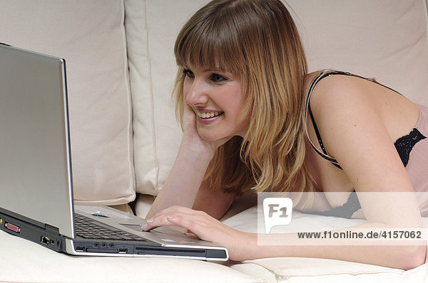Woman on a couch with laptop