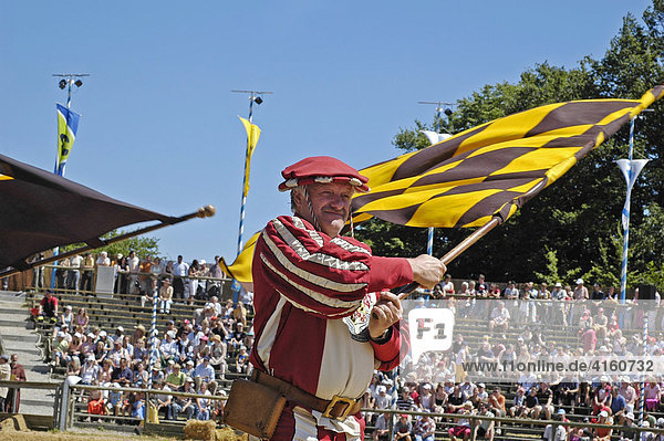 Standard bearer in mediaeval medieval costume with yellow black flag  knight festival Kaltenberger Ritterspiele  Kaltenberg  Upper Bavaria  Germany