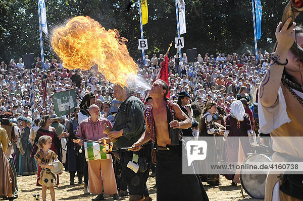 Fire-eater at move of the comedians in mediaeval medieval costume in arena  knight festival Kaltenberger Ritterspiele  Kaltenberg  Upper Bavaria  Germany