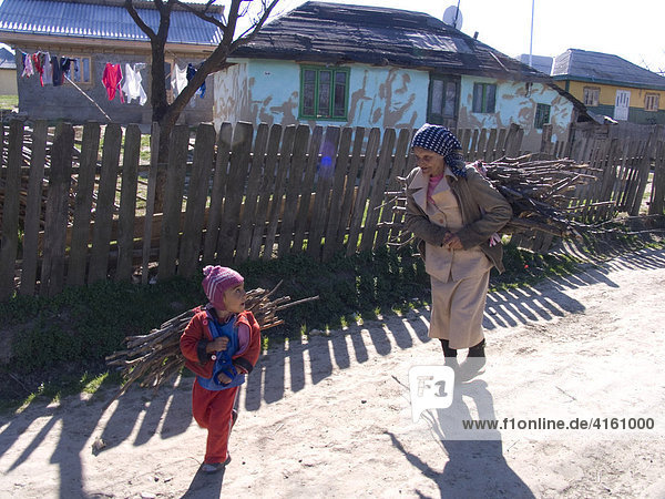 Child and older woman with small twigs  Guilia  Romania