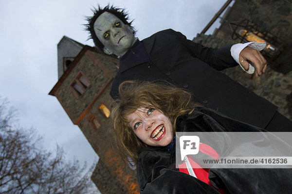 Traditional Halloween spectacle in the castle Frankenstein. A monster frightens a girl  castle Frankenstein  Hessen  Germany