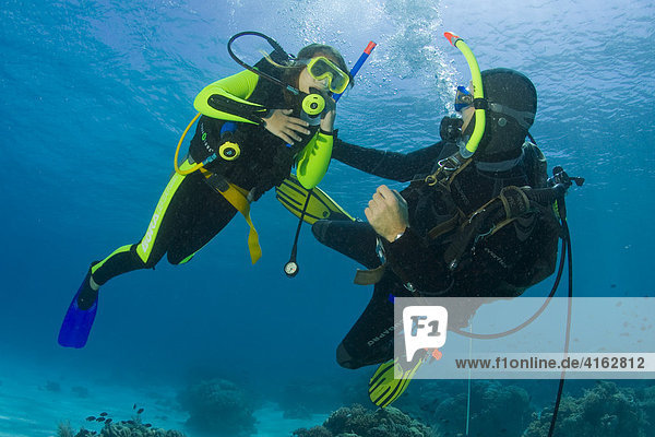 Girl taking scuba lessons in the ocean Indonesia  Asia