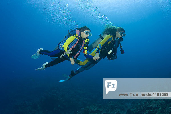 Two young scuba divers  Caribbean  Roatan  Honduras  Central America