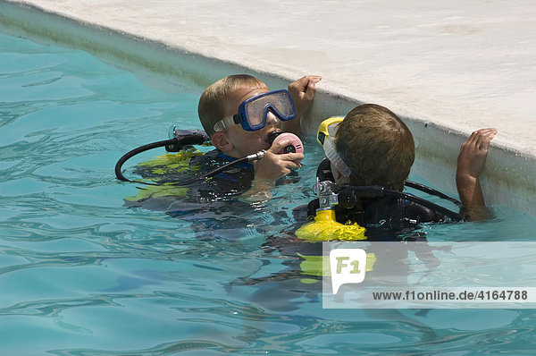 Two divers with diving equipment at the side of a pool  Fuerteventura  Canary Islands  Spain