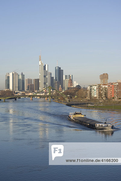 Skyline von Frankfurt am Main aus dem Osten mit der Commerzbank und einem Frachtkahn auf dem Main  Frankfurt am Main  Hessen  Deutschland